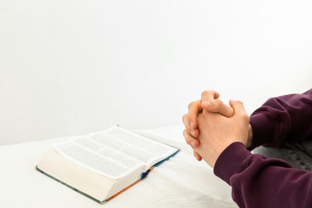 a person sitting at a table with an open book