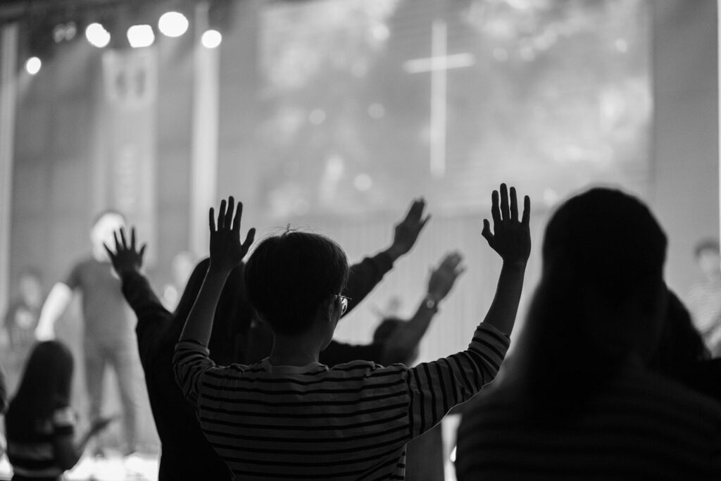 People with raised hands at a concert oration