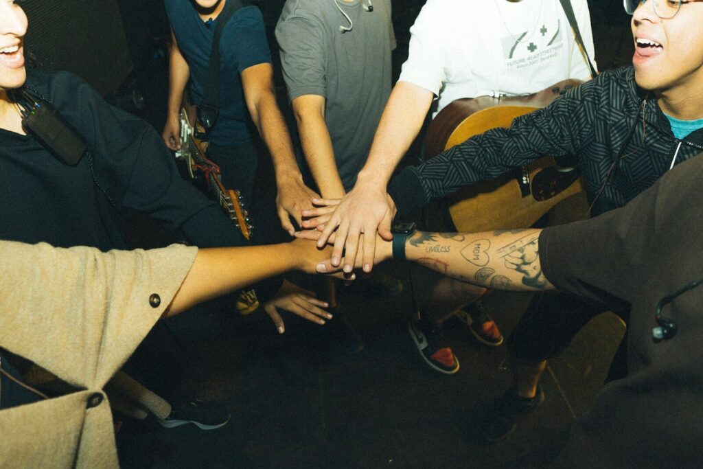 a group of people holding hands in a circle